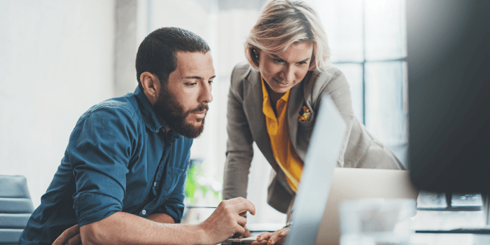 woman-and-man-looking-at-computer-together