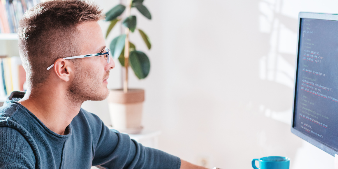 Man looking at software quality assurance processes on computer screen 