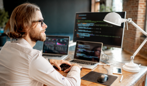 man on computer looking at test automation metrics